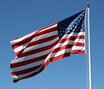 American flag depicting pride and patriotism under blue skies FREE Stock Photo, american flag,  patriotism,  national pride picture
