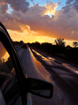 Scenic view from car window during sunset KOSTENLOSES Stock-Photo-Bild, reisen, winding road, pfützen